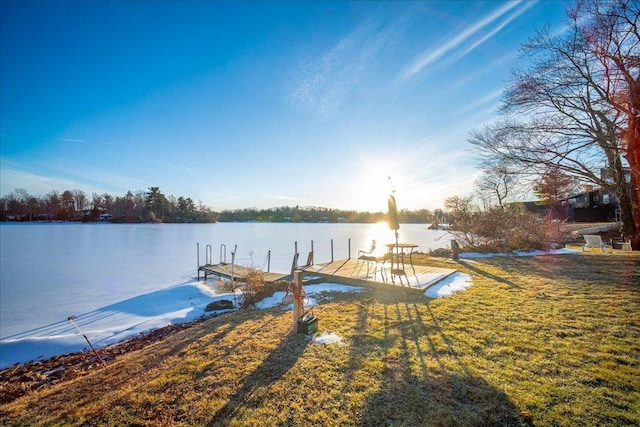 view of dock with a water view and a yard