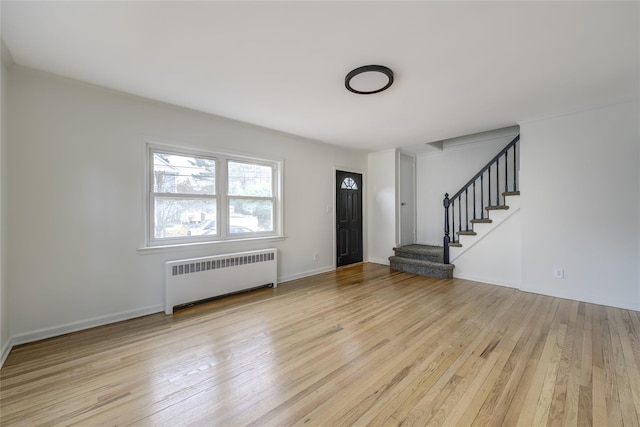 foyer entrance with radiator and light hardwood / wood-style floors