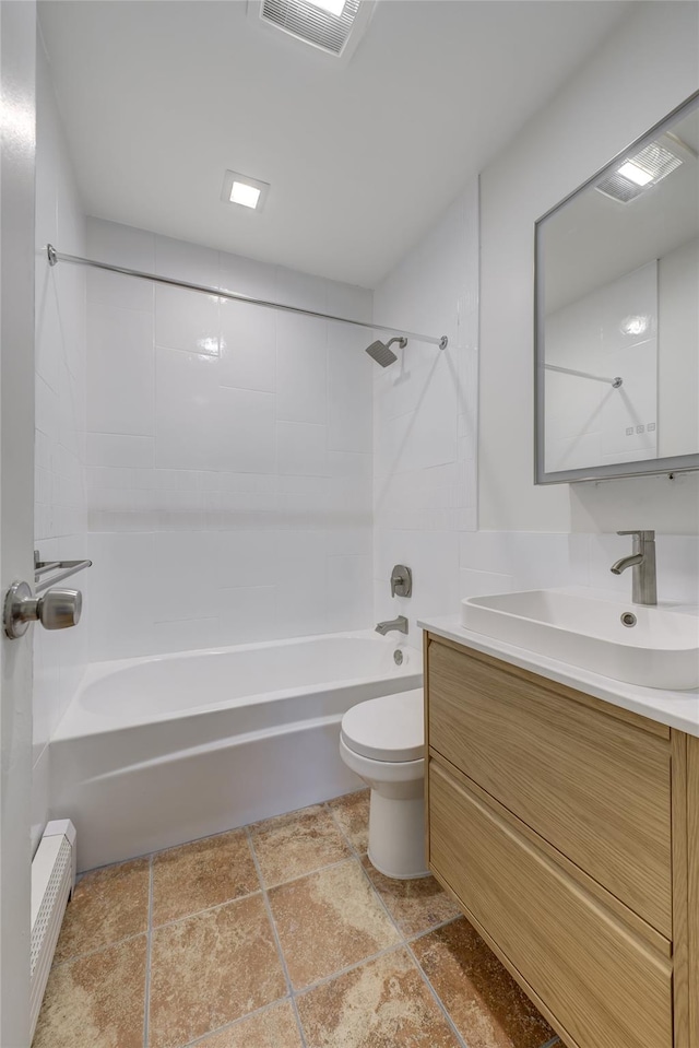 full bathroom featuring vanity, toilet, and tiled shower / bath combo