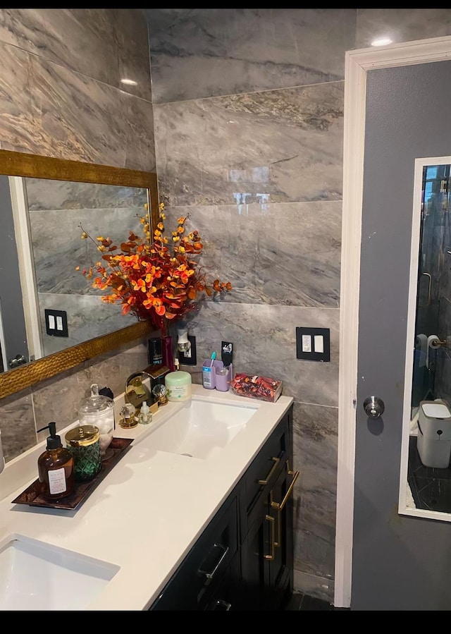 bathroom with vanity and tile walls