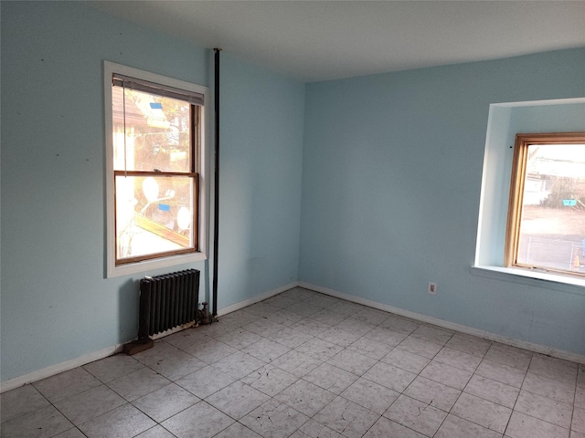 unfurnished room featuring radiator