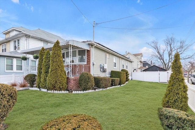 view of side of property with a yard