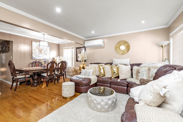 living room featuring ornamental molding, wood-type flooring, and a wall mounted AC