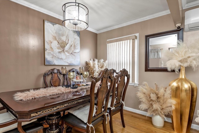 dining area with hardwood / wood-style flooring, crown molding, a wall mounted AC, and a chandelier