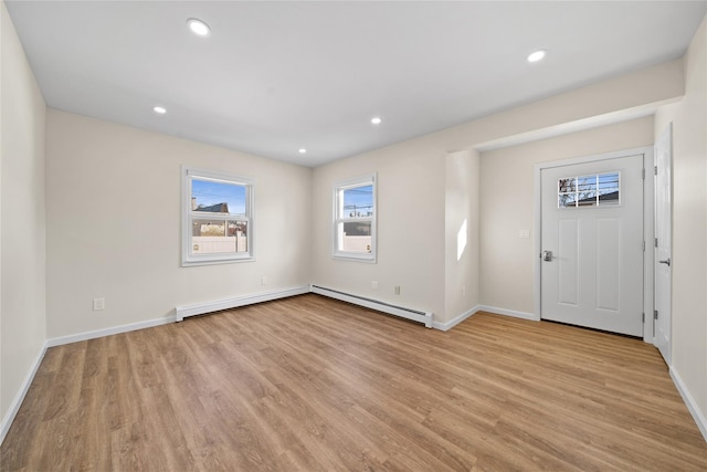 entryway with baseboard heating and light hardwood / wood-style floors