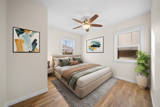 bedroom with hardwood / wood-style floors and ceiling fan