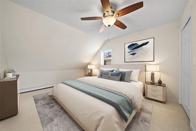 bedroom with vaulted ceiling, light carpet, a baseboard radiator, a closet, and ceiling fan