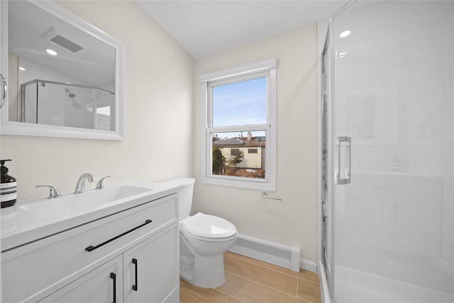 bathroom with vanity, wood-type flooring, toilet, and walk in shower