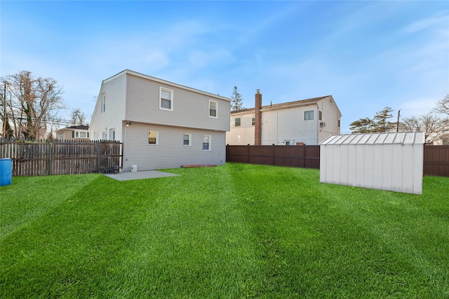 back of house featuring a yard, a patio, and a storage unit