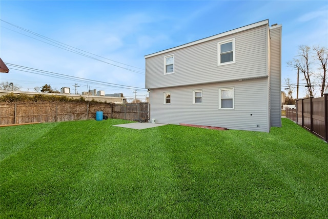 rear view of property with a patio and a yard