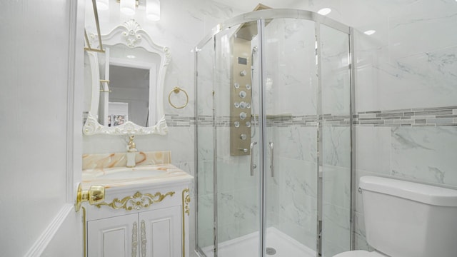 bathroom with vanity, toilet, and a shower with shower door