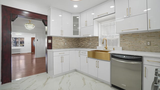 kitchen with pendant lighting, sink, dishwasher, white cabinetry, and radiator heating unit