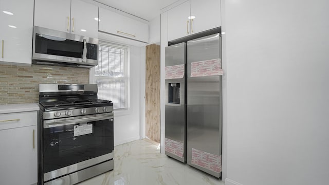 kitchen with white cabinetry, stainless steel appliances, and decorative backsplash