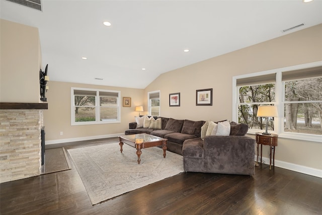 living area featuring dark wood finished floors, lofted ceiling, baseboards, and visible vents