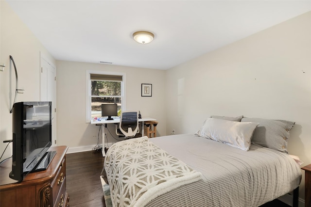 bedroom featuring visible vents, baseboards, and dark wood-style flooring