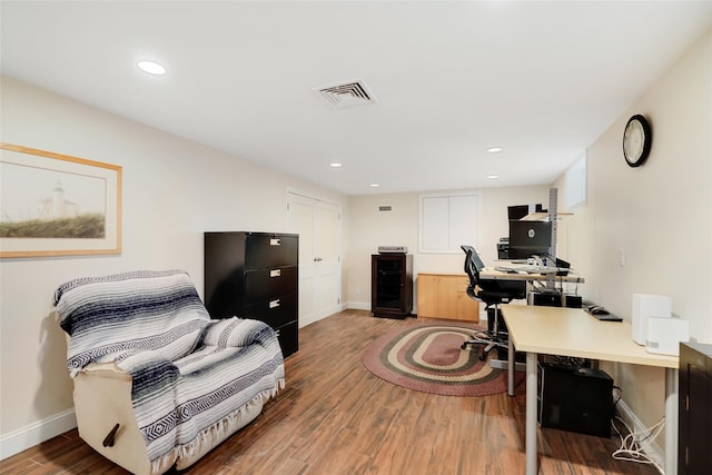 office space with recessed lighting, wood finished floors, visible vents, and baseboards