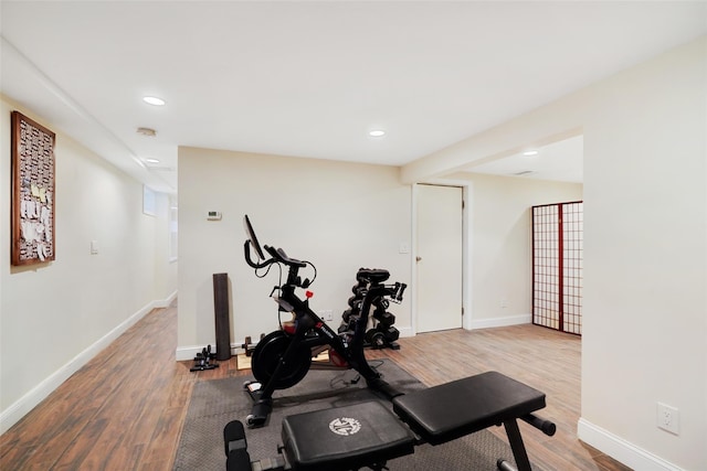 workout area with wood finished floors and baseboards