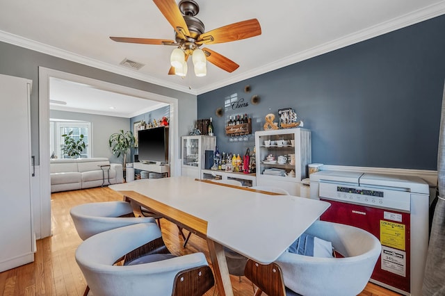 dining space with ornamental molding, ceiling fan, and light hardwood / wood-style floors