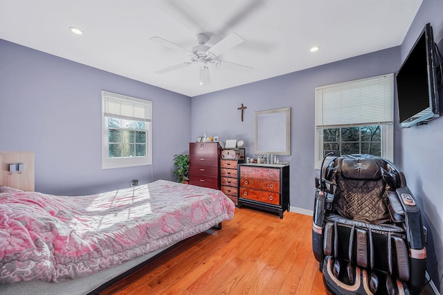 bedroom with ceiling fan and light wood-type flooring