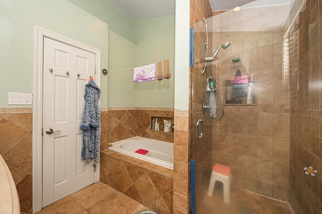 bathroom with tile patterned floors, independent shower and bath, and tile walls