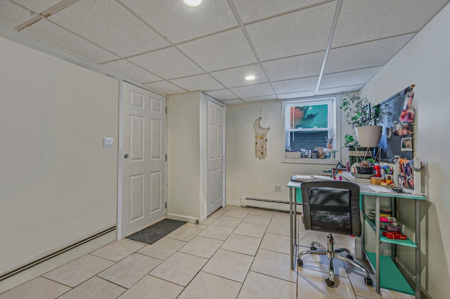 tiled office space with baseboard heating and a drop ceiling