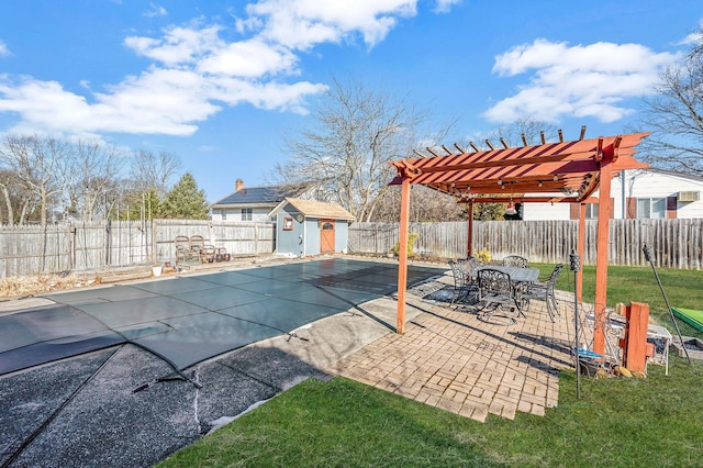 view of pool with a storage unit, a pergola, and a patio