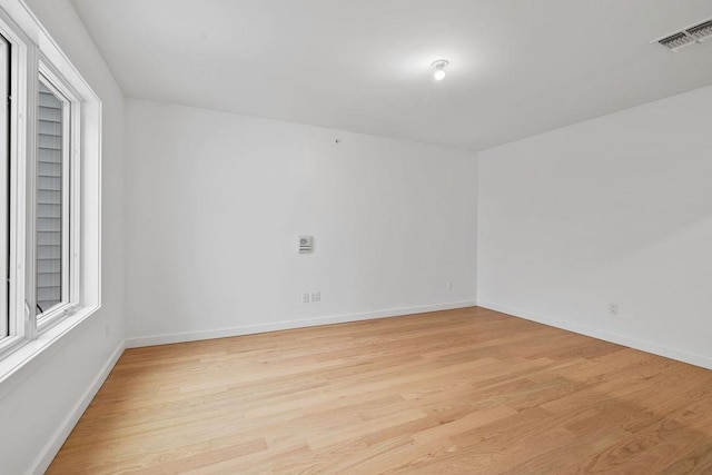 unfurnished room featuring light hardwood / wood-style floors