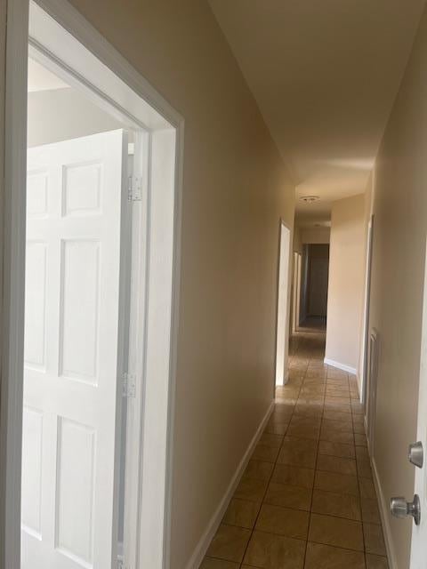 hall with dark tile patterned flooring