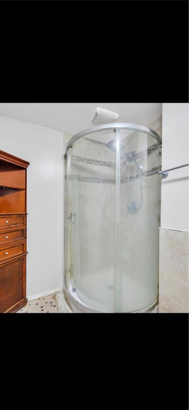 bathroom featuring an enclosed shower