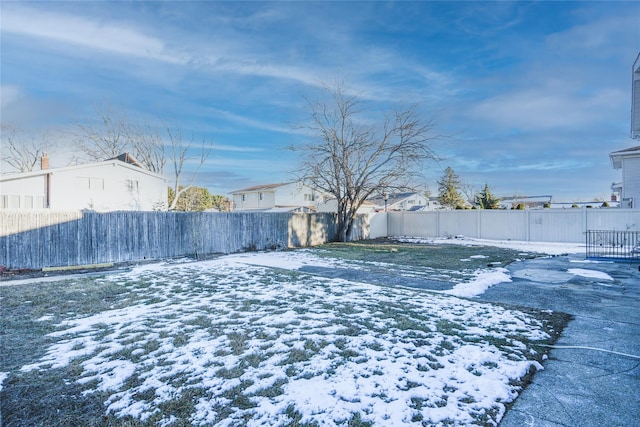 view of yard layered in snow