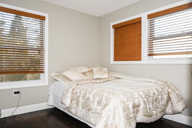 bedroom with dark wood-type flooring