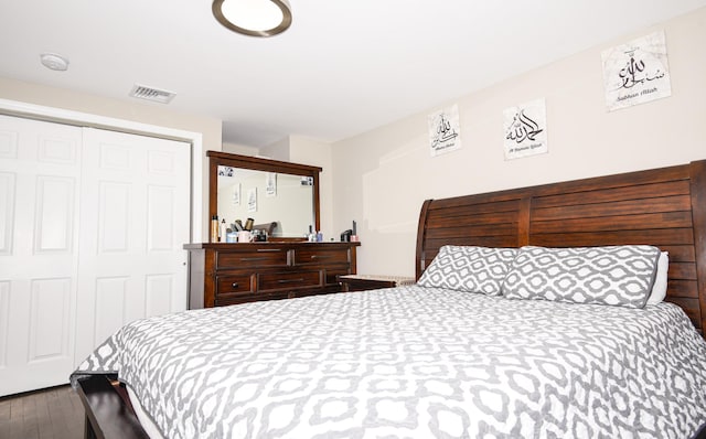 bedroom featuring hardwood / wood-style floors and a closet