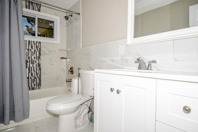 full bathroom featuring vanity, toilet, shower / bath combo with shower curtain, and tile walls