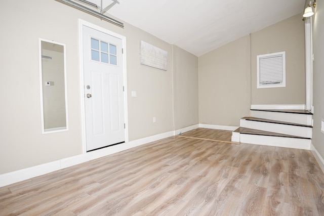 entrance foyer with lofted ceiling and light wood-type flooring