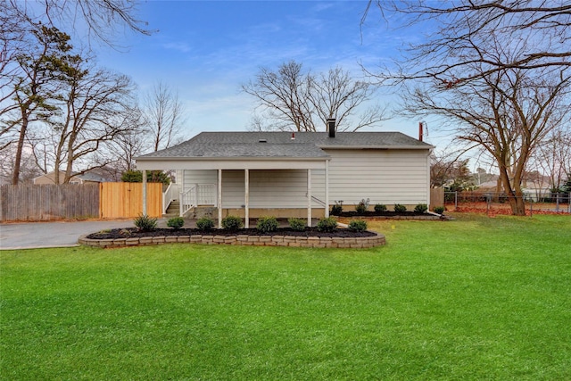 rear view of house with a lawn