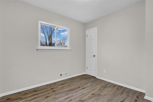 unfurnished room featuring wood-type flooring