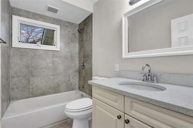 full bathroom featuring vanity, toilet, and tiled shower / bath combo