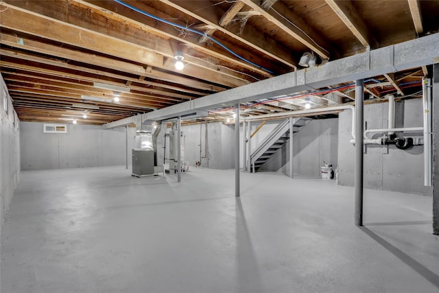 basement featuring heating unit and water heater