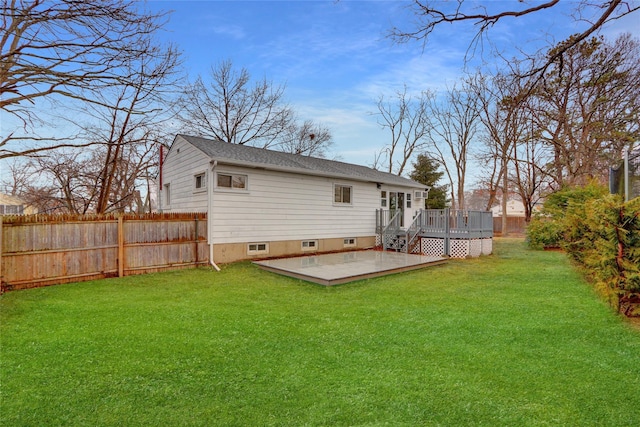 rear view of house with a wooden deck and a yard