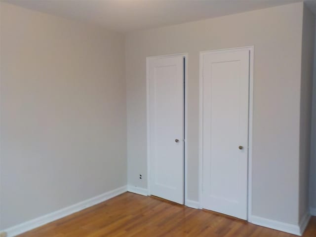 unfurnished bedroom featuring hardwood / wood-style flooring