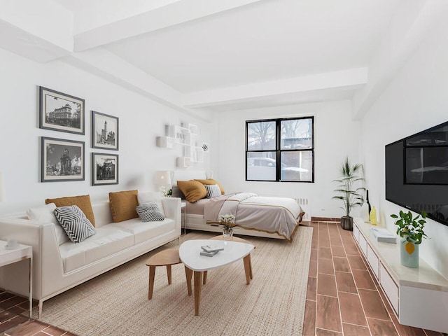 bedroom featuring radiator and beam ceiling