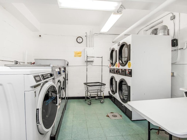 clothes washing area with stacked washing maching and dryer and separate washer and dryer