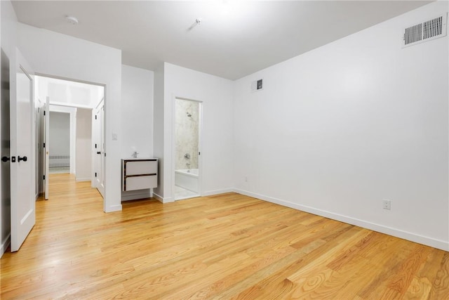 unfurnished room with light hardwood / wood-style floors