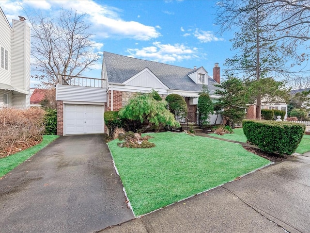 80-51 Little Neck Pkwy, Glen Oaks, NY 11004 - view of front of home with brick siding, driveway, a front yard, an attached garage, and a chimney