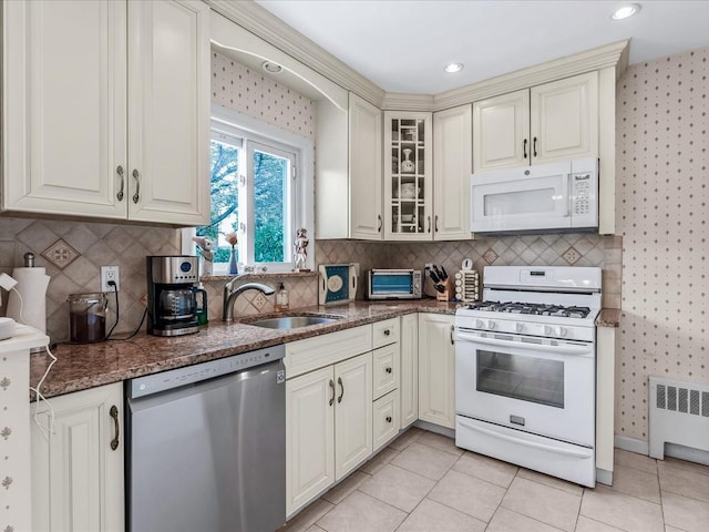 80-51 Little Neck Pkwy, Glen Oaks, NY 11004 - kitchen with white appliances, a sink, radiator heating unit, wallpapered walls, and dark stone countertops