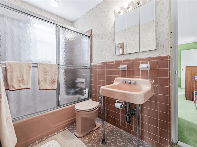 80-51 Little Neck Pkwy, Glen Oaks, NY 11004 - full bath featuring tile walls, combined bath / shower with glass door, wallpapered walls, toilet, and wainscoting