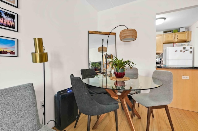 dining space with light hardwood / wood-style flooring