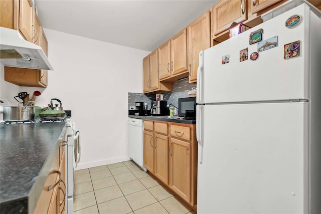 kitchen featuring tasteful backsplash, white appliances, and light tile patterned flooring