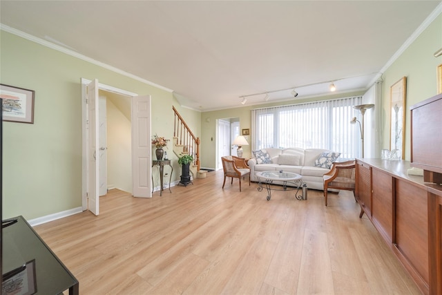 living room with crown molding, light hardwood / wood-style flooring, and rail lighting