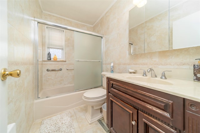 full bathroom featuring tile walls, enclosed tub / shower combo, ornamental molding, vanity, and toilet